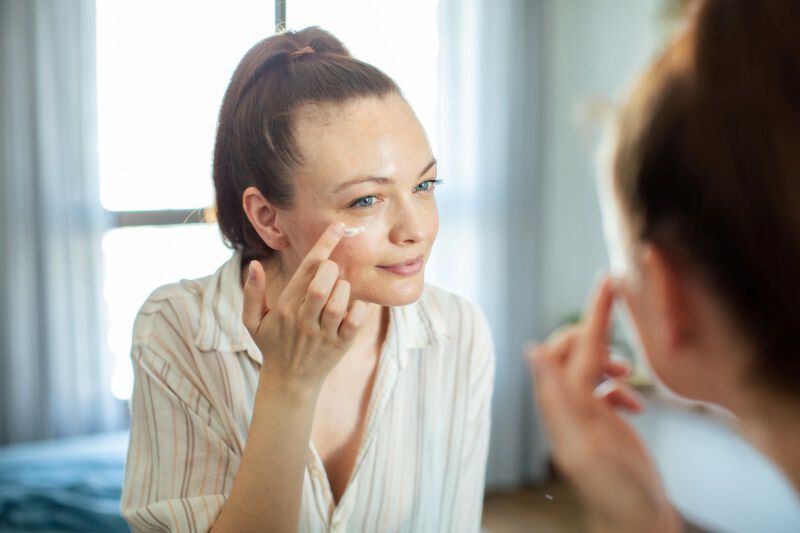 woman applying day cream