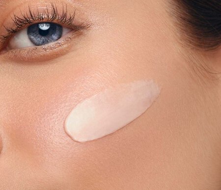 woman with face cream on her cheek