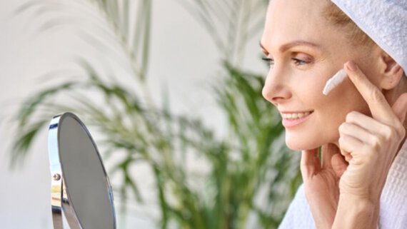 Woman in her 40s creams her face