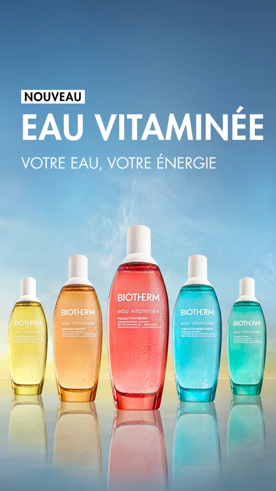 Brume corporelle vitaminee Eau Vitaminee de Biotherm : cinq flacons colores (jaune, orange, rouge, turquoise et vert) alignes sur un fond degrade bleu et jaune, avec le texte « Nouveau – Eau Vitaminee. Brume corporelle vitaminee. Votre brume, votre energie. »